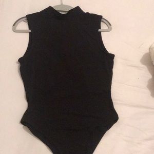Black bodysuit with an opening in the back.